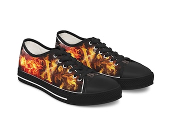 May include: A pair of black canvas low-top trainers with a white sole. The trainers feature a colourful design of flames and floral patterns.