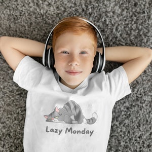 May include: A young person with red hair wearing white headphones and a white t-shirt with a cartoon cat and the text "Lazy Monday".