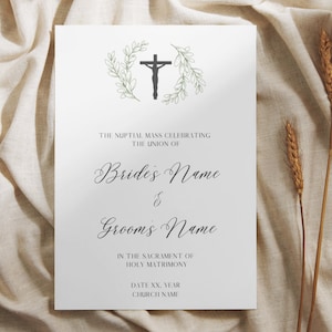 May include: A white wedding invitation with elegant script. The design features a black crucifix within a green wreath at the top. Text includes "Bride's Name", "Groom's Name", and details about the ceremony.