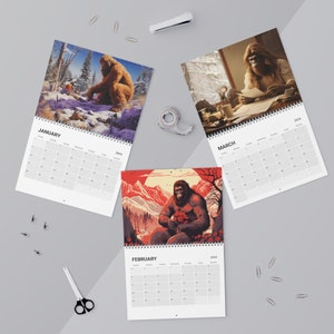 May include: A 2024 calendar featuring monthly illustrations of Bigfoot. Each month features a different illustration of Bigfoot in a different setting. The calendar is printed on white paper with black text. The months of January, February, and March are shown.
