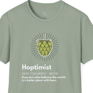 May include: A light green t-shirt featuring a graphic of a hop cone and the text "Hoptimist (HOP-TUH-MIST) - NOUN A person who believes the world is a better place with beer."