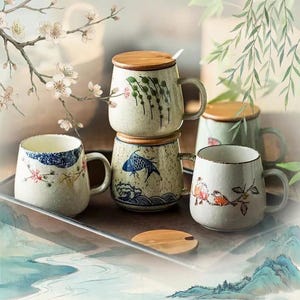 May include: A selection of ceramic mugs with lids, adorned with hand-painted designs. The mugs display floral, fish, and bird motifs in blue, red, and green. Each mug has a handle and a wooden lid.