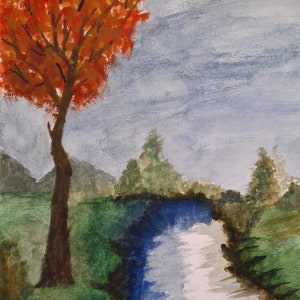Árbol de otoño junto al río.