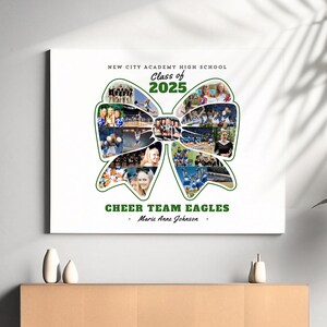 May include: A white canvas print with a green bow made of photos of a cheerleading squad. The text "New City Academy High School" is at the top, followed by "Class of 2025". Below the bow is the text "Cheer Team Eagles - Marie Anne Johnson - "