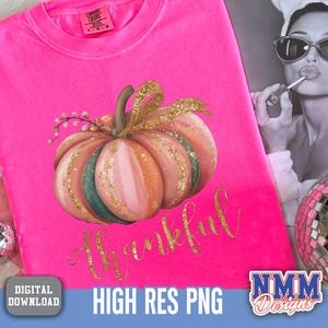 May include: A vibrant pink sweatshirt featuring a pumpkin design and the word "Thankful" in gold script. The pumpkin is painted in pink, orange, and green with gold glitter. The shirt also has the text "HIGH RES PNG".