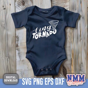 May include: A navy blue baby onesie with the text "tiny tornado" in white lettering. A white tornado graphic is above the text.