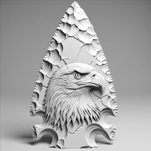 May include: A white, carved arrowhead featuring a detailed relief of an eagle's head. The eagle is depicted in profile, with intricate feather and facial details. The arrowhead has a textured surface and a triangular shape.