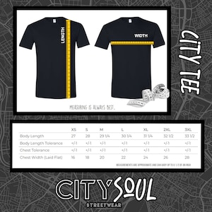 May include: A size chart for a City Tee, showing measurements in inches for XS, S, M, L, XL, 2XL, and 3XL sizes. The chart includes measurements for body length, body length tolerance, chest tolerance, and chest width (laid flat).