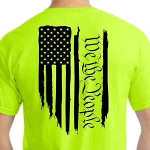 May include: A neon green t-shirt with a black distressed American flag and the words 'We the People' printed on the back.