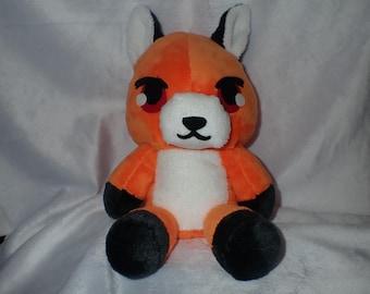 May include: Orange and white plush toy fox with black eyes and a black nose. The fox is sitting on a white surface.