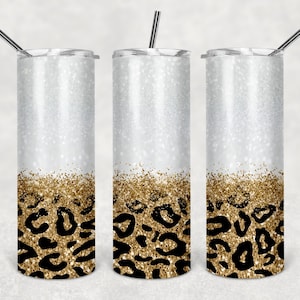 May include: Three stainless steel tumblers with a white glitter finish and a gold glitter and leopard print design.