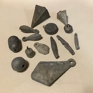 Antique lead weighted fishing sinkers. Vintage collectible tackle lot of 14. All unique cast lead and many with stamped weight for display.