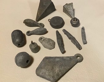 Antique lead weighted fishing sinkers. Vintage collectible tackle lot of 14. All unique cast lead and many with stamped weight for display.