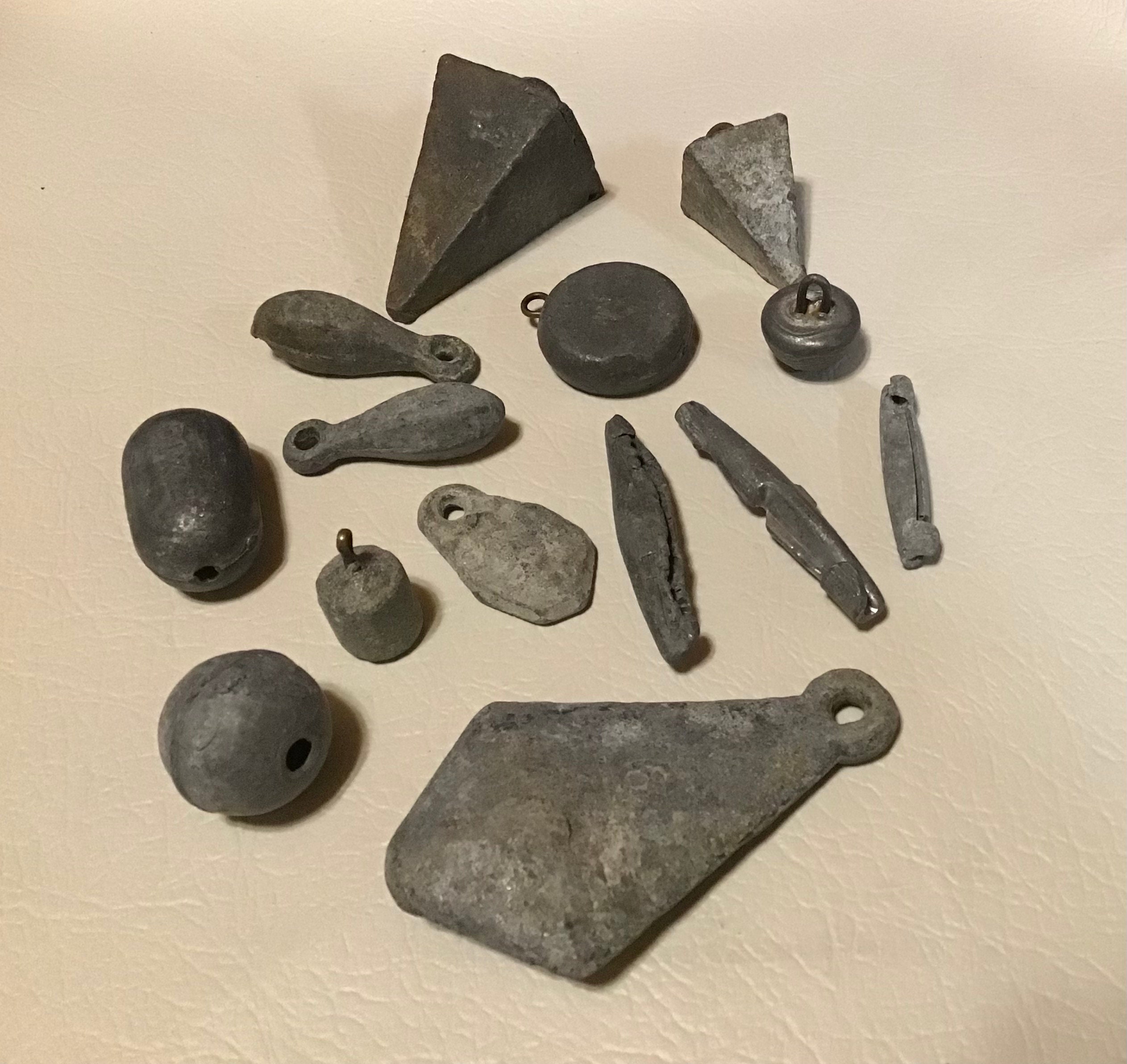 Antique lead weighted fishing sinkers. Vintage collectible tackle lot of 14. All unique cast lead and many with stamped weight for display.