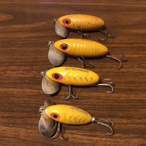 Rare jitterbug lure collection. Vintage Fred Arbogast fishing tackle. Yellow bugs all different silver scales and metal lips. Great Display