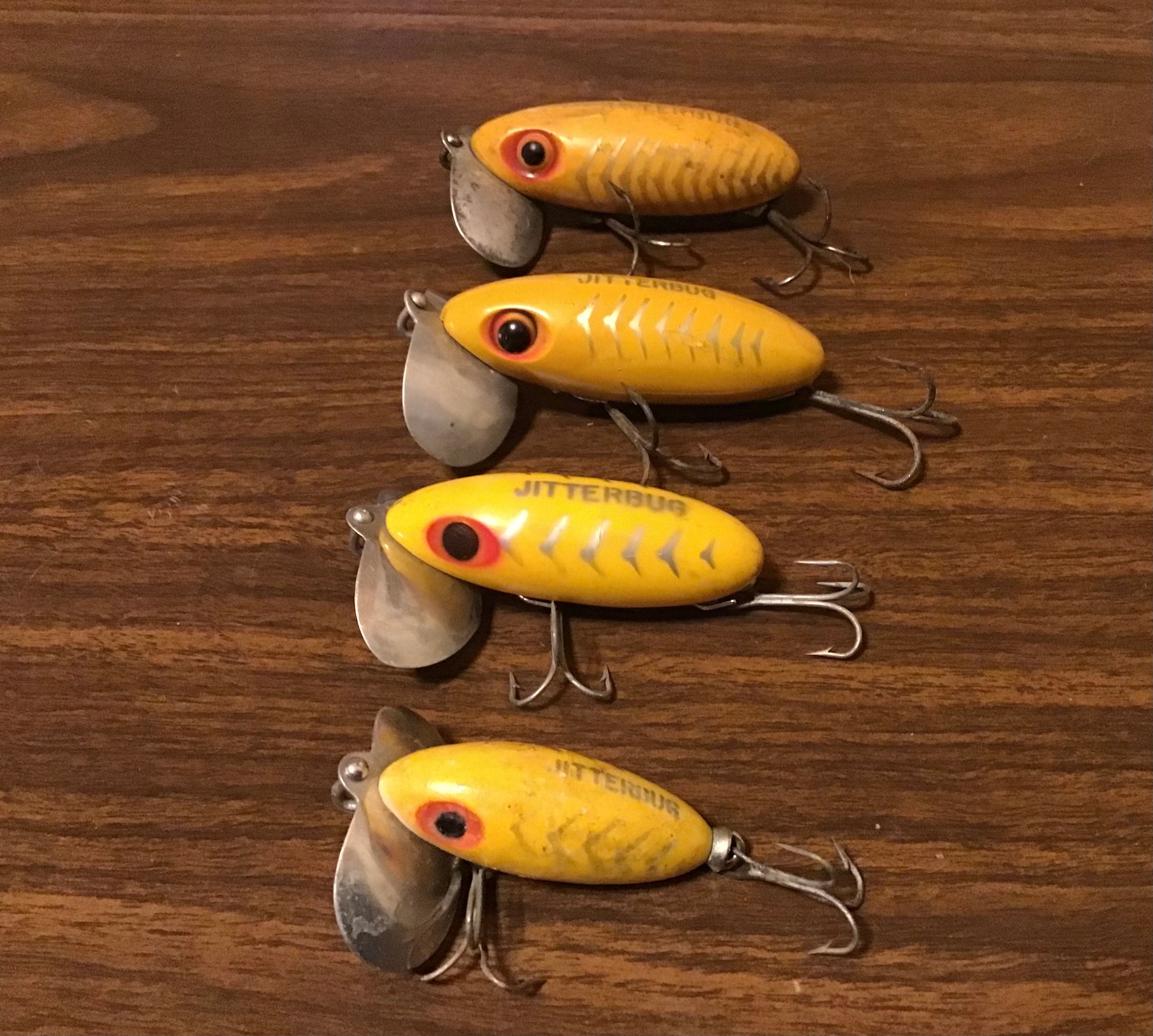 Rare jitterbug lure collection. Vintage Fred Arbogast fishing tackle. Yellow bugs all different silver scales and metal lips. Great Display