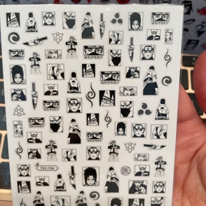 May include: A sheet of black and white anime character stickers with the text "Hatake Kakashi" repeated multiple times. The stickers feature a variety of poses and expressions of the character. The sheet also includes a variety of other symbols and designs.