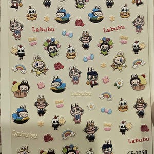 May include: Sheet of decorative stickers featuring various cartoon characters, including bunnies, skulls, and figures in hats and outfits. The stickers are in various colors, with the word "Labubu" printed on them. The sheet also has the text "CF-1058".
