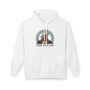 May include: White hoodie with a front pocket and a graphic of a man wearing a hat, inside a blue braided circle. The text "THE RULER" is below the graphic. The hoodie is made of a soft material.