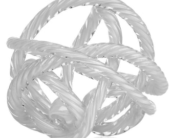 May include: A clear glass sculpture of a knot, with a twisted rope design. The sculpture is made of clear glass and has a smooth, polished finish.