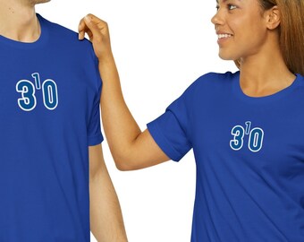 May include: Two people wearing royal blue t-shirts with the number "3'0" printed in white on the front. The person on the left is wearing blue jeans. The person on the right is wearing blue jeans.