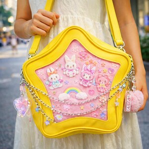 May include: A yellow star-shaped handbag with a clear front panel displaying cartoon bunnies, a rainbow, and stars on a pink background. The bag has a chain strap and decorative charms.