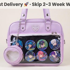 May include: A lavender satchel bag with a clear front panel displaying colorful anime-style character buttons. The bag has a matching heart-shaped coin purse attached by a chain. The text "Starrazer Bags" is on the bag.