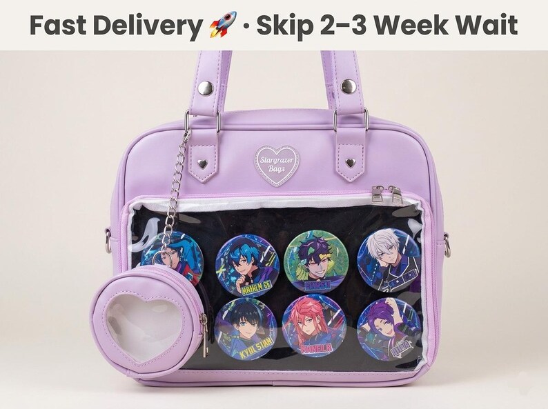 May include: A lavender satchel bag with a clear front panel displaying colorful anime-style character buttons. The bag has a matching heart-shaped coin purse attached by a chain. The text "Starrazer Bags" is on the bag.