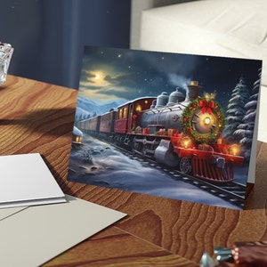 May include: A Christmas card featuring a red and black steam engine train with a wreath on the front, traveling through a snowy winter landscape at night.