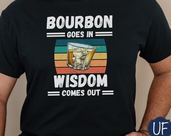 May include: A black t-shirt with a vintage-style graphic that reads "Bourbon goes in = Wisdom comes out =" with a glass of bourbon and ice cubes in the center.