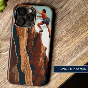 May include: iPhone 15 Pro Max phone case featuring a mountain climber ascending a rock face. The case has a colorful illustration of a person in an orange shirt and dark shorts, climbing a rock face with ropes. The case has a glossy finish.