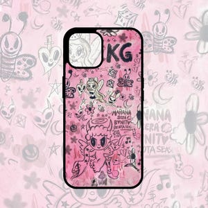 May include: A pink phone case with a black border. The case is covered in a variety of hand-drawn illustrations, including a winged angel, a devil, a heart, and stars. The text "MANANA SERA BONITO" is written on the case.