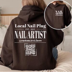 May include: A brown hoodie with a white print that says "Local Nail Plug EST. 2025 NAIL ARTIST @custom.text.here" and a QR code. The hoodie also has a white print on the front that says "NAIL ARTIST @custom.here".