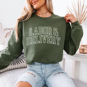 May include: A green sweatshirt with the text "LABOR & DELIVERY" in white outlined letters.