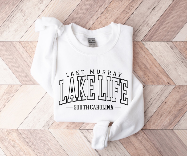 May include: White sweatshirt with black text that reads "Lake Murray Lake Life - South Carolina".