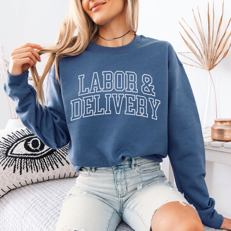 May include: A blue sweatshirt with the text "LABOR & DELIVERY" in white outlined letters.