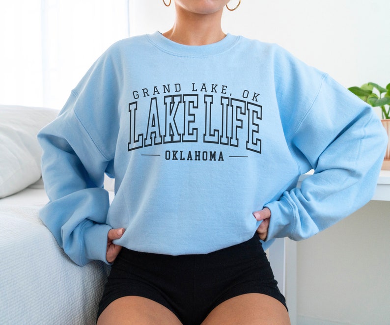 May include: Light blue sweatshirt with black text that reads "Grand Lake, OK Lake Life Oklahoma".