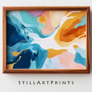 May include: Abstract art print in a wooden frame. The artwork features a vibrant mix of colors, including blues, oranges, pinks, and gold accents. The text "STILLARTPRINTS" is printed at the bottom of the frame.