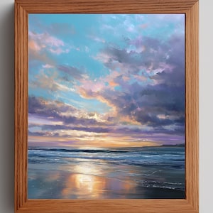Puede incluir: Pintura de paisaje enmarcada que representa una playa al atardecer. El cielo es una mezcla de azul, morado y naranja, con nubes oscuras. El mar refleja los colores del cielo, y la obra está en un marco de madera.