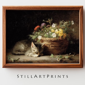 May include: A framed print featuring a sleeping kitten next to a woven basket overflowing with colorful flowers. The artwork has a vintage aesthetic, with a dark background and the text "STILLARTPRINTS" at the bottom.