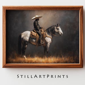 May include: A framed print featuring a person in traditional attire riding a gray horse. The person wears a sombrero and a detailed black outfit. The horse is saddled and stands in a field of tall grass. The print is in a wooden frame. The text "STILLARTPRINTS" is at the bottom.