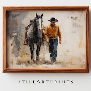 May include: A framed art print depicts a cowboy walking alongside a gray horse. The cowboy wears a brown jacket, blue jeans, and a black hat. The artwork has a textured, painterly style with neutral tones and the text "STILLARTPRINTS" at the bottom.