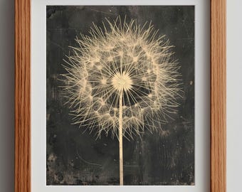 May include: A framed print featuring a dandelion seed head in a sepia tone against a dark background. The dandelion is centered, with delicate seed filaments radiating outwards. The frame is made of light brown wood.