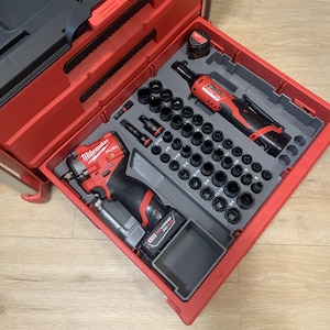 May include: A red and black Milwaukee tool set with a variety of sockets and power tools. The set includes a ratchet, impact wrench, and a selection of sockets in various sizes, all neatly organized in a red case.