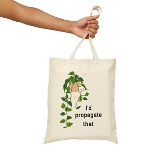 May include: A white tote bag with a green plant illustration and the text "I'd propagate that".