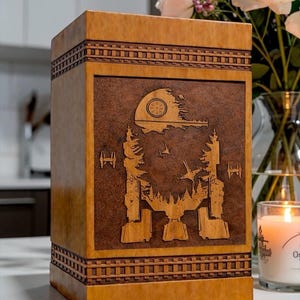 Space inspired memorial urn box featuring intricate galactic walker and cosmic scene engraving on handcrafted wooden cremation urn.