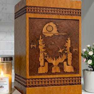 Handmade wooden cremation urn box featuring a detailed Galactic Walker Memorial Design with a sci-fi galaxy scene including space ships and cosmic elements engraved on a premium wooden memorial box for ashes.