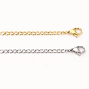 May include: Two necklace extender chains. One is gold-colored, the other is silver-colored. Each chain has a lobster clasp at one end and a series of small, interconnected links. The chains are designed to add length to necklaces or bracelets.