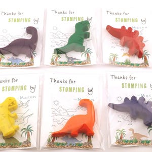 May include: Six dinosaur-shaped crayons in various colors, including purple, green, red, yellow, orange, and blue. Each crayon is packaged with a card that reads "Thanks for stomping by!" and the name "Mason".