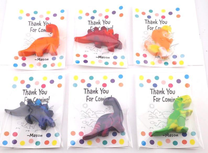 May include: Six dinosaur-shaped crayons in clear plastic bags, each on a card with colorful polka dots and the text "Thank You For Coming!" and "-Mason". The crayons are various colors, including orange, red, and green.